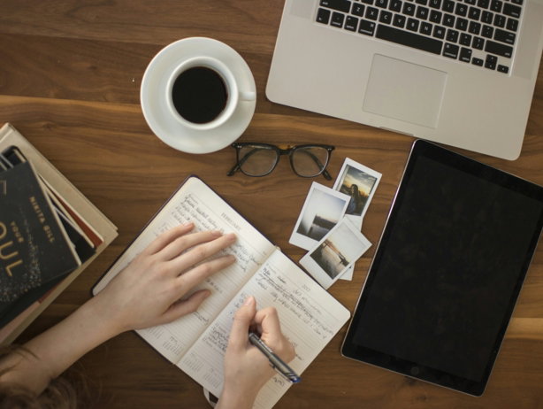 person-holding-ballpoint-pen-writing-on-notebook.jpg person holding ballpoint pen writing on notebook